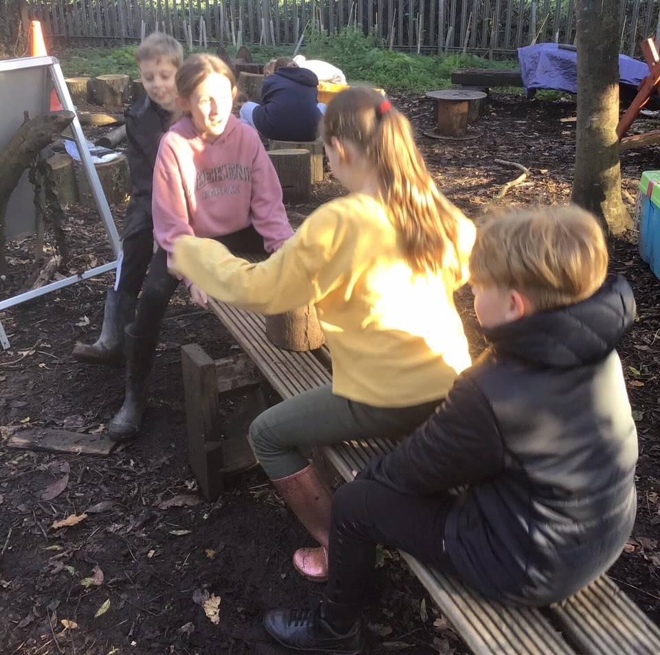 Children playing on a home-made see-saw