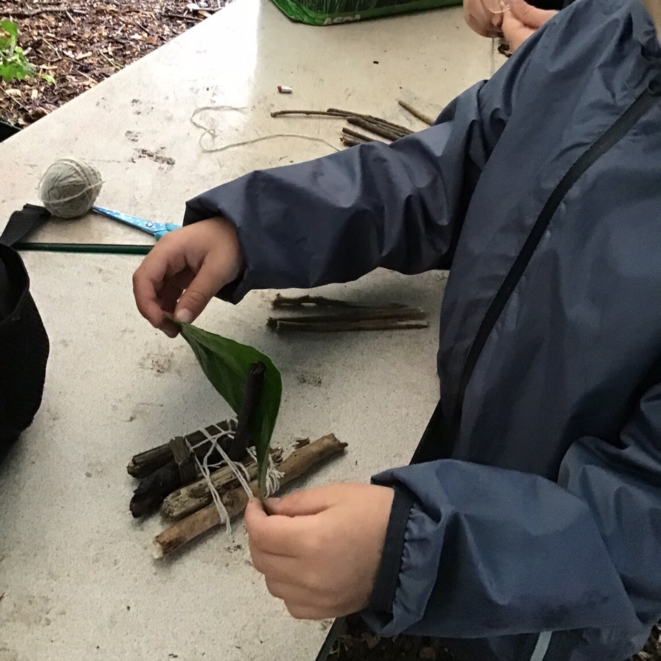 A child making a raft from natural materials