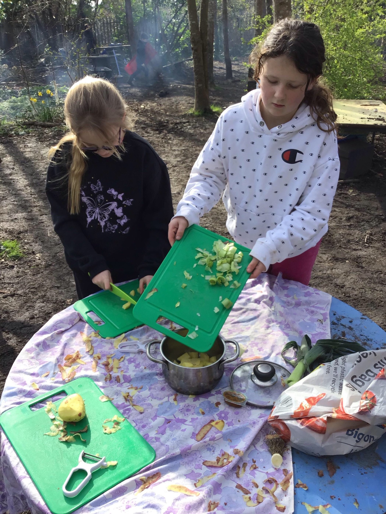 Children preparing vegetables outdoors