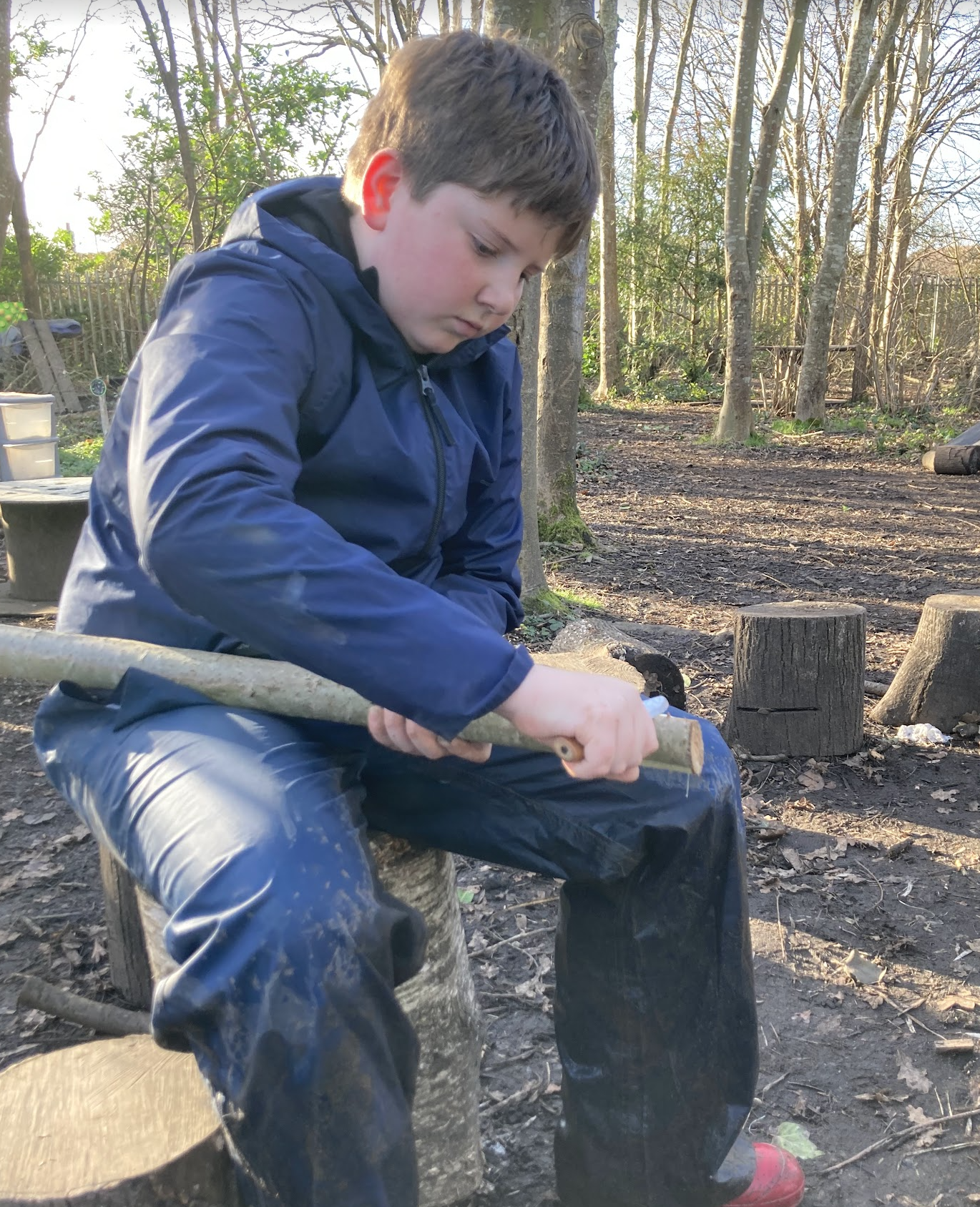 A boy whittling wood