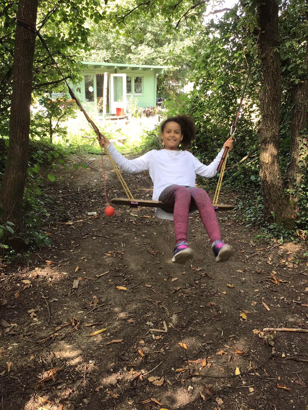 A girl on a homemade swing